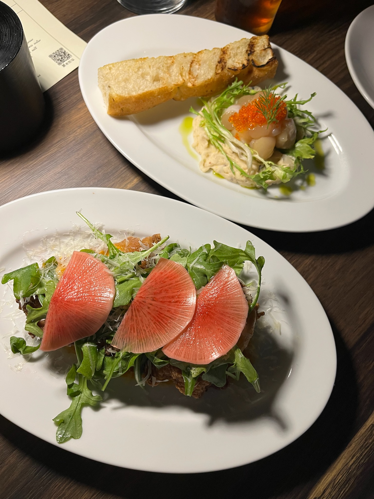 Both starters on the table: fried chicken with watermelon radish and smoked scallops with salmon roe and focaccia